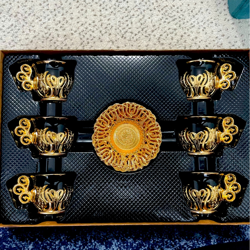 Beautiful gold and black Turkish tea cups with matching gold saucers